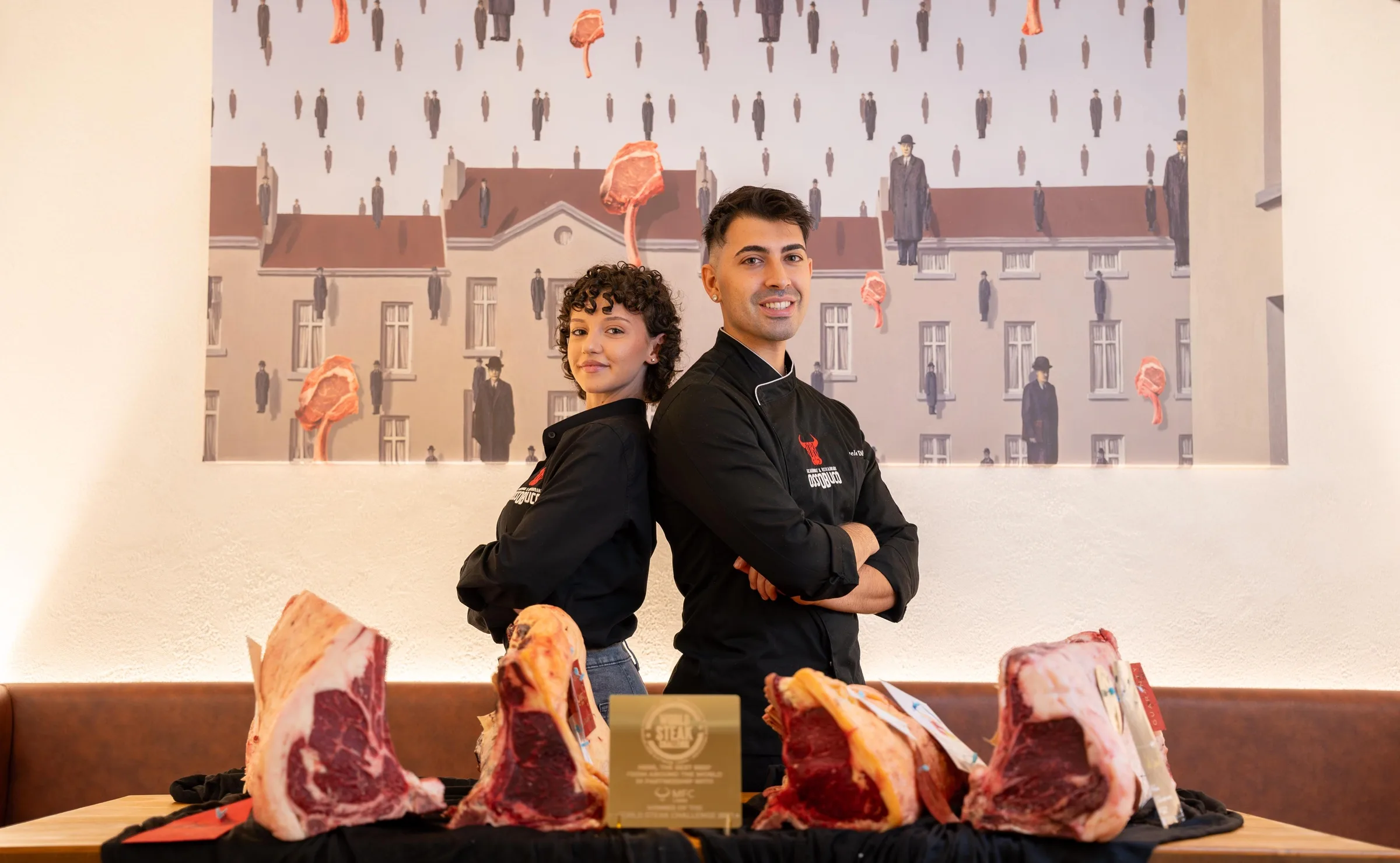 Emanuele and Francesca, founders of Ossobuco, with dry-aged cuts of beef